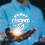 A person holding a glowing certified badge symbolizing the concept of "What Is CMMC" in cybersecurity certification.